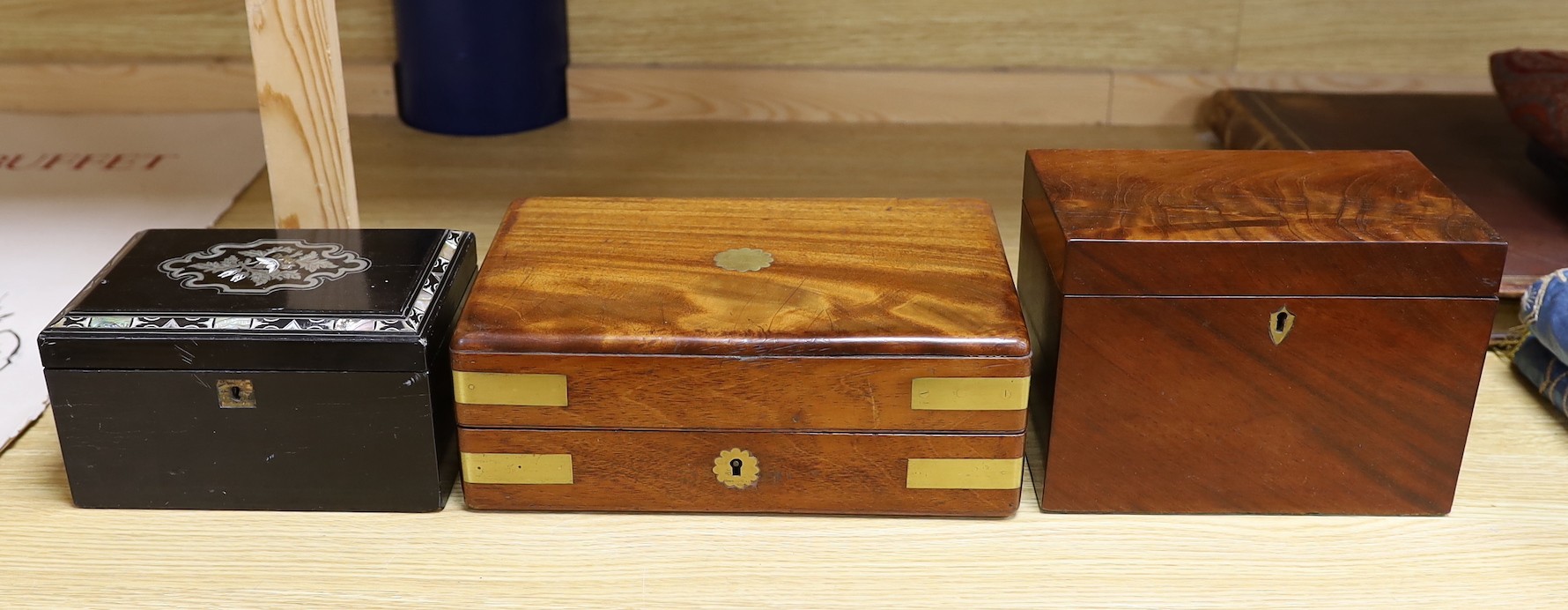 A Victorian mahogany brass bound sewing box, a mother of pearl and silver metal inlaid ebony tea caddy and another caddy, Ebony caddy 19 cms wide x 9 cms high